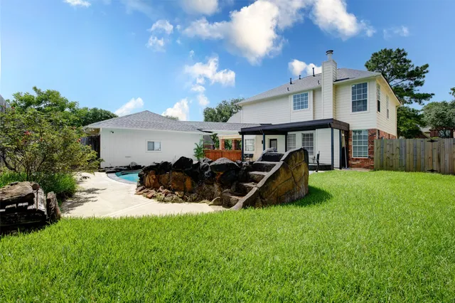 a view of a house with backyard porch and sitting area