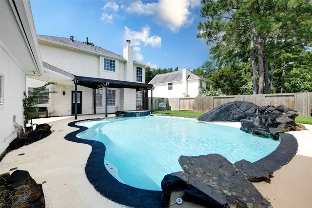 a swimming pool with outdoor seating and yard