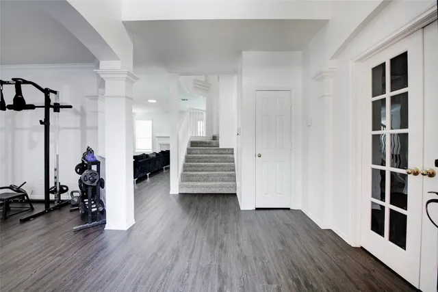 a view of a living room with wooden floor and stairs