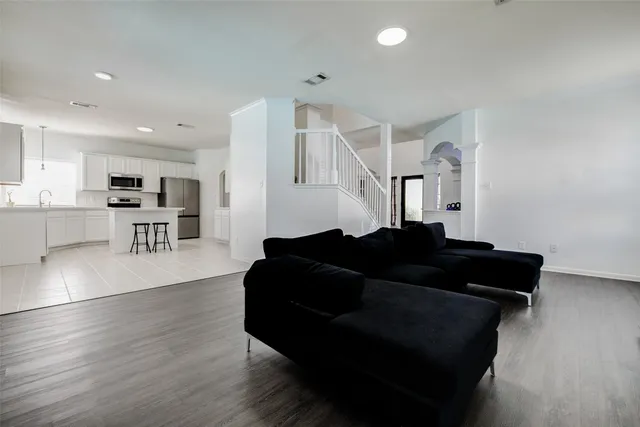 a living room with furniture and wooden floor