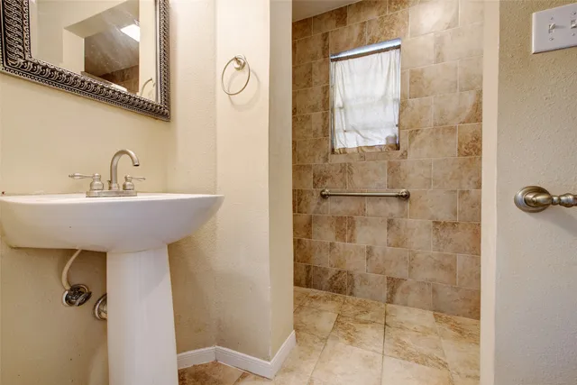 a bathroom with a sink a mirror and shower