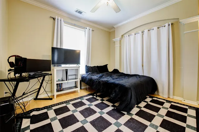 a bedroom with a bed and wooden floor