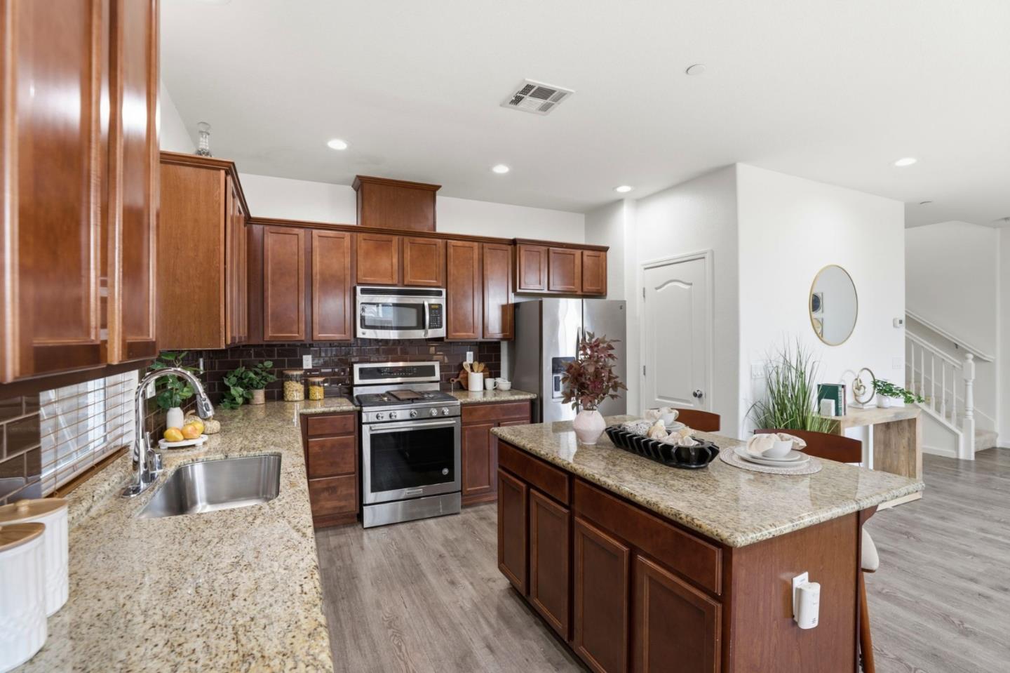 170 Sturla Way Gilroy, CA 95020 - Photo 11 of 64 a kitchen with granite countertop stainless steel appliances and wooden cabinets