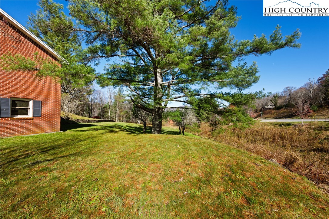 986 Ransom Street Blowing Rock, NC 28605 - Photo 12 of 17 a yellow house with trees in front of it