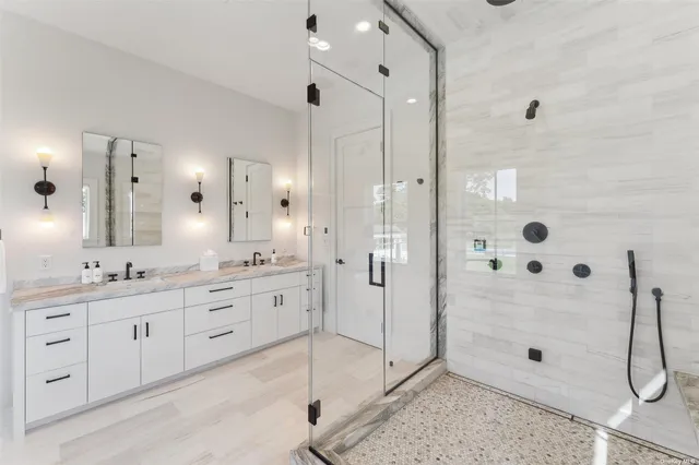 a bathroom with a shower sink and mirror