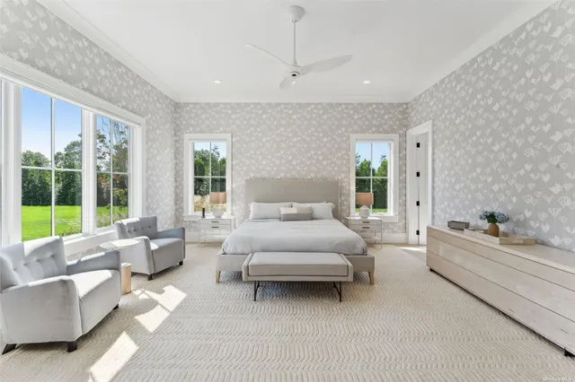 a spacious bedroom with a large bed couch and a window