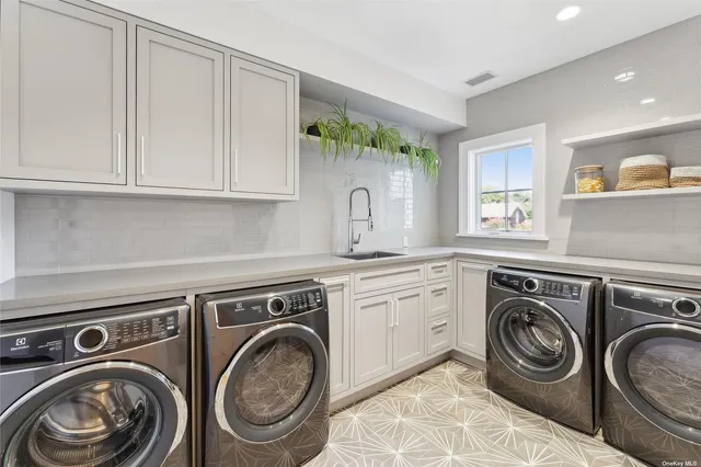 a utility room with sink dryer and washer