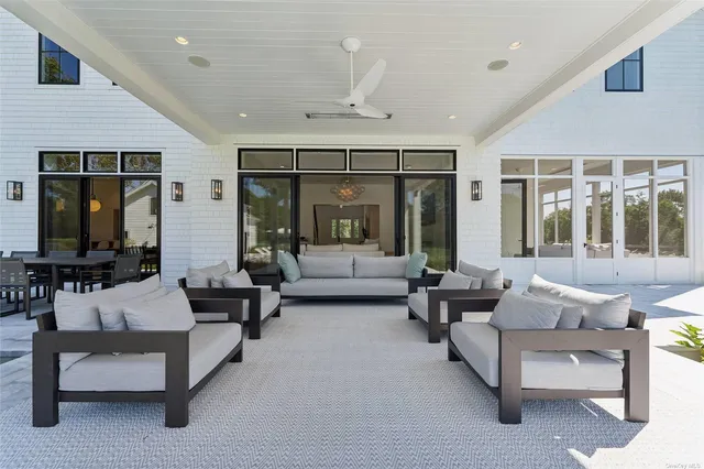 a view of a patio with table and chairs under an umbrella
