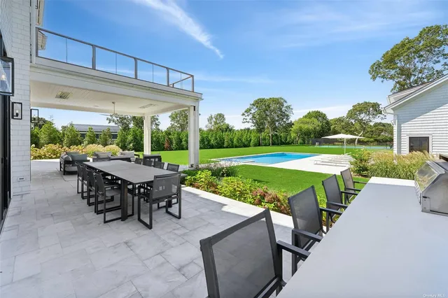 a view of house with yard and swimming pool