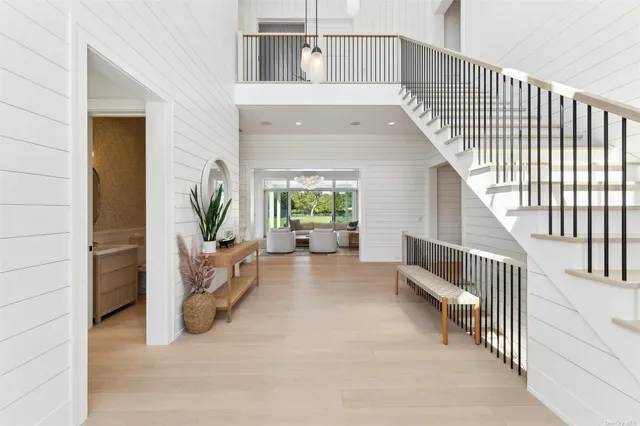 a view of entryway and hall with wooden floor