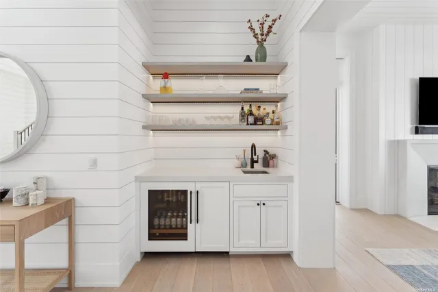 a kitchen with white cabinets and a fireplace