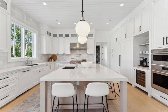 a large kitchen with a table and chairs