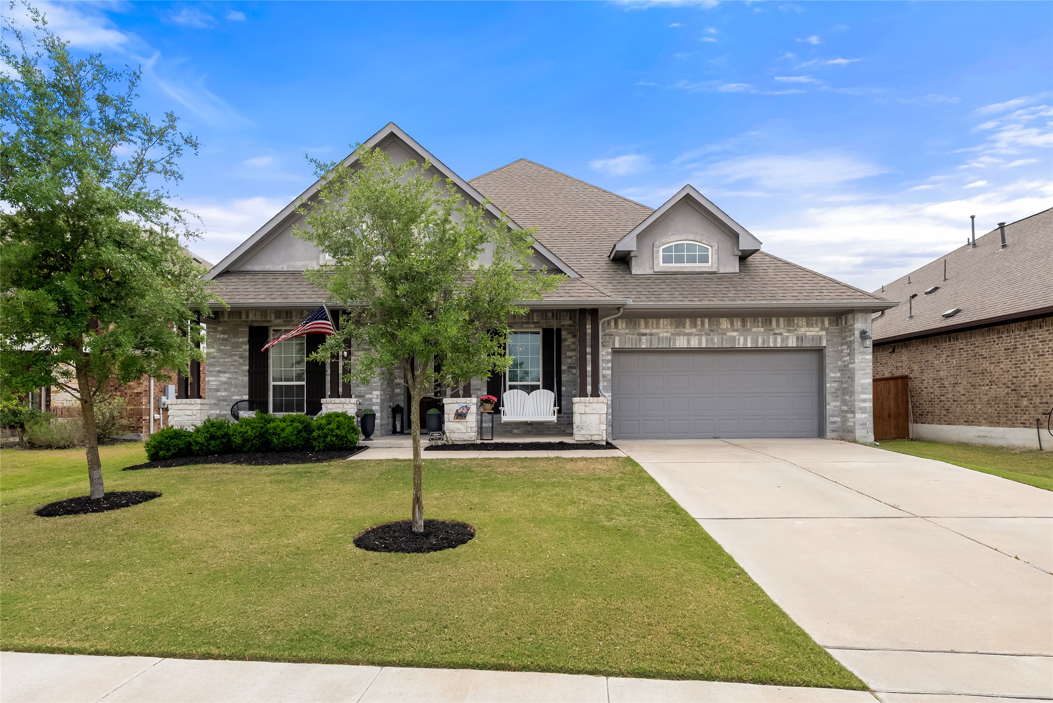 19901 Isle Of Glass Street Pflugerville, TX 78660 - Photo 1 of 40 a front view of a house with a yard and garage