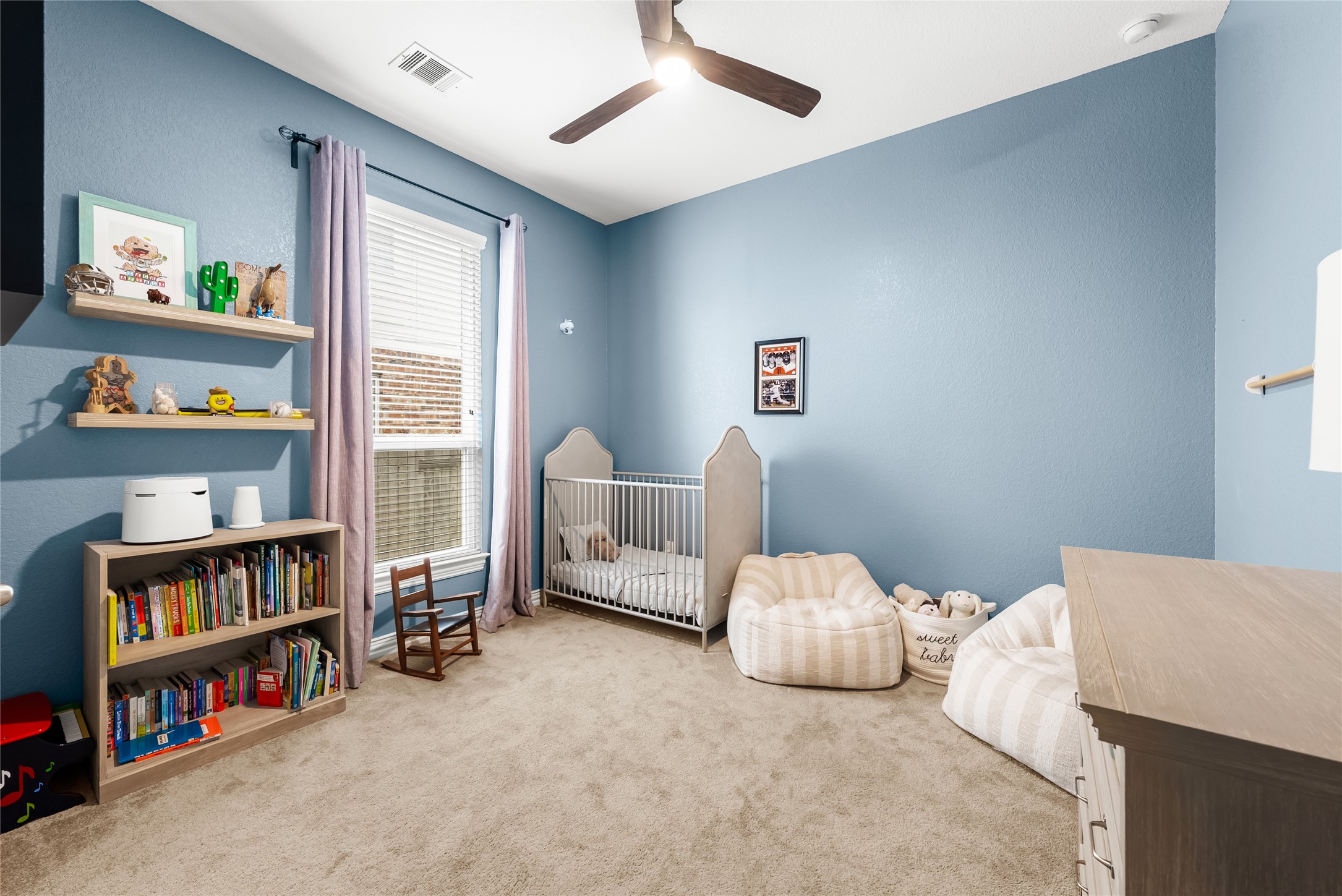 19901 Isle Of Glass Street Pflugerville, TX 78660 - Photo 11 of 40 a bedroom with bed and a book shelf