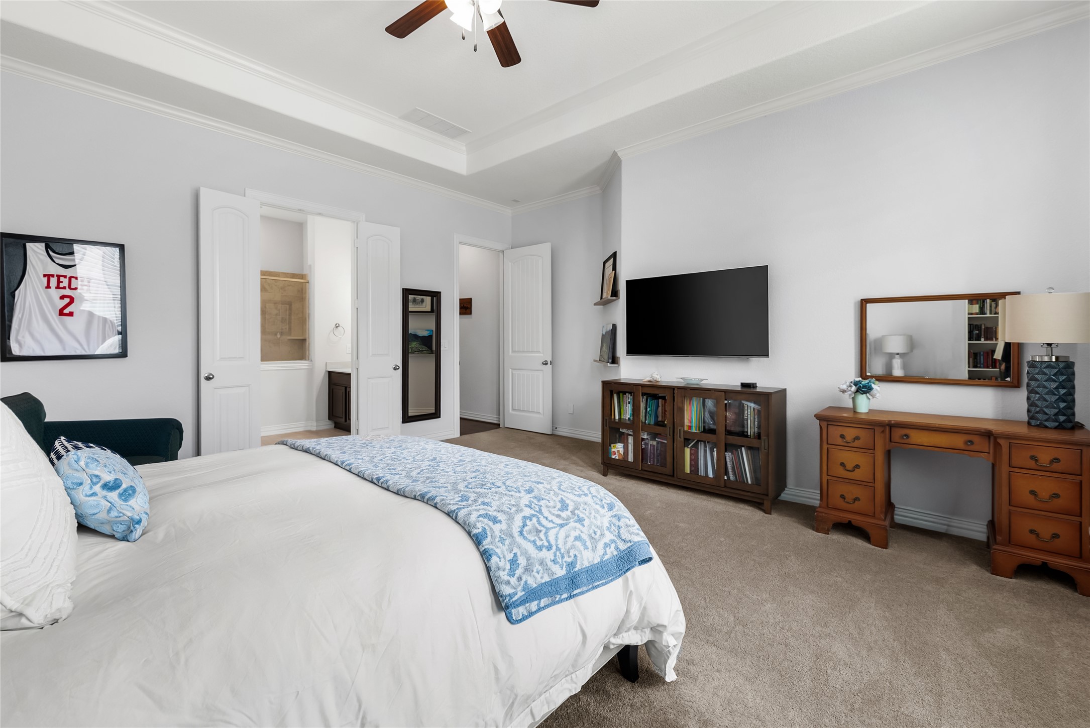 19901 Isle Of Glass Street Pflugerville, TX 78660 - Photo 27 of 40 a bedroom with a bed and a flat screen tv