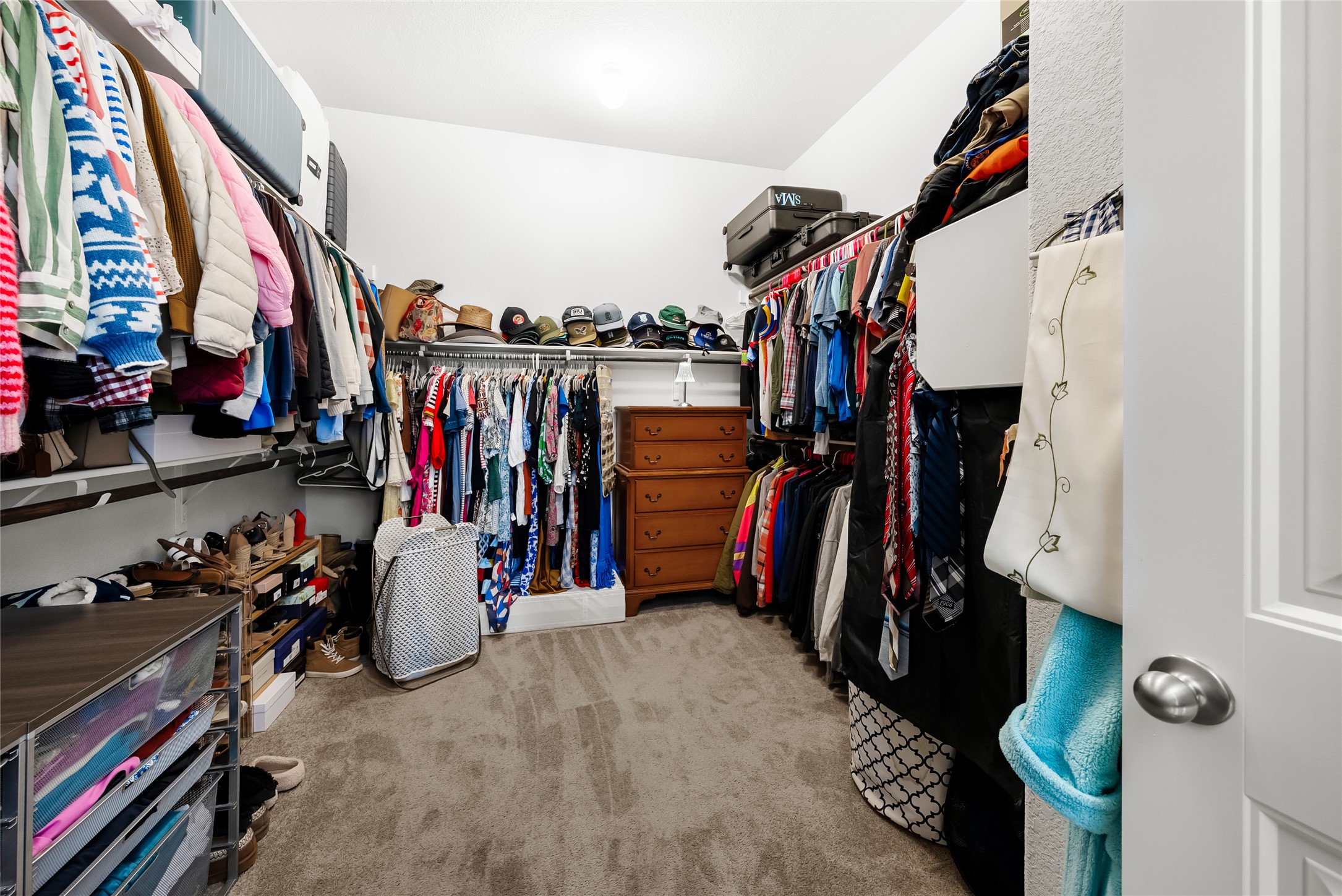19901 Isle Of Glass Street Pflugerville, TX 78660 - Photo 30 of 40 a view of walk in closet with clothes and shoes