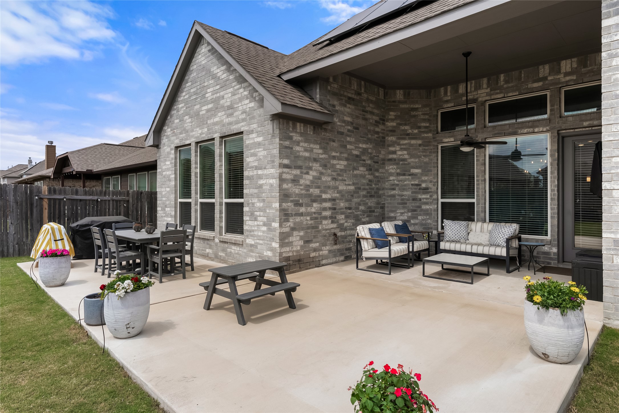 19901 Isle Of Glass Street Pflugerville, TX 78660 - Photo 33 of 40 a view of a patio with table and chairs potted plants with barbeque grill and potted plants