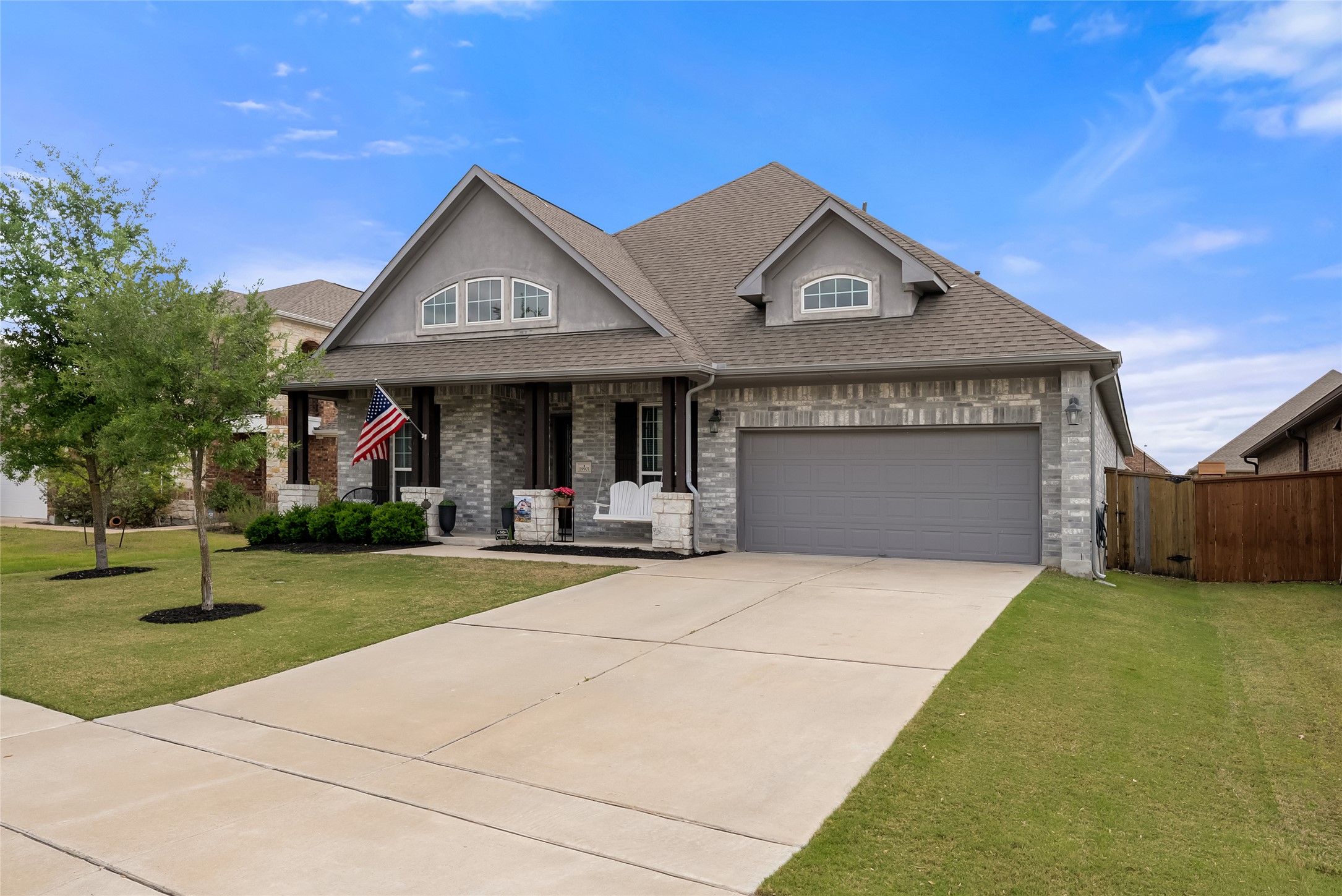 19901 Isle Of Glass Street Pflugerville, TX 78660 - Photo 4 of 40 a front view of a house with garden