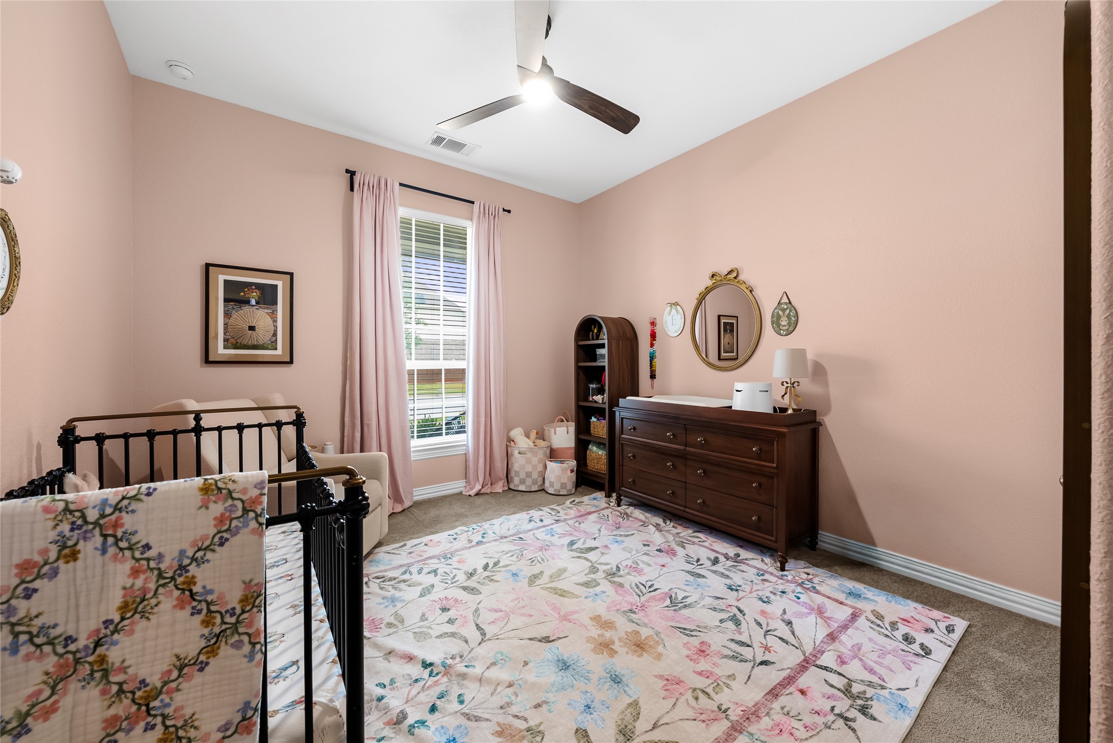 19901 Isle Of Glass Street Pflugerville, TX 78660 - Photo 9 of 40 a bedroom with a bed and a dresser in it