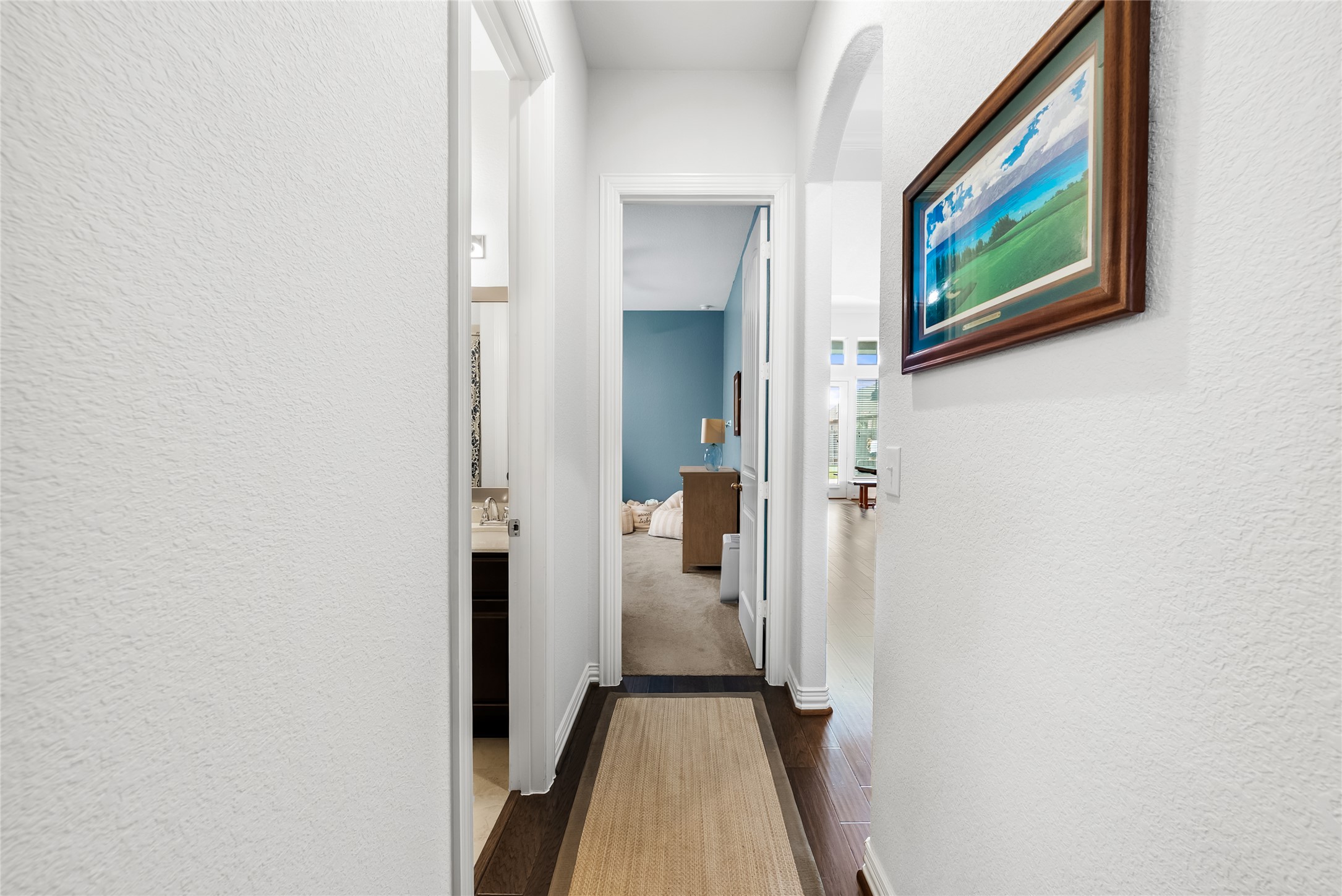 19901 Isle Of Glass Street Pflugerville, TX 78660 - Photo 10 of 40 a view of a hallway with paintings on the wall