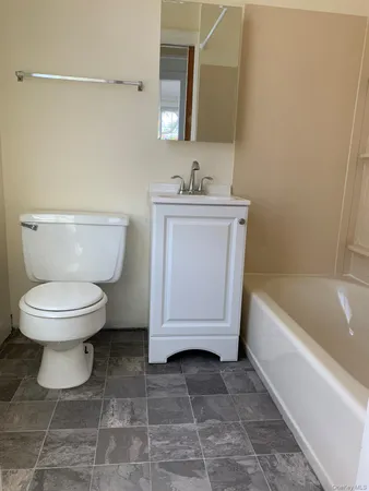 a bathroom with a toilet a sink and bathtub