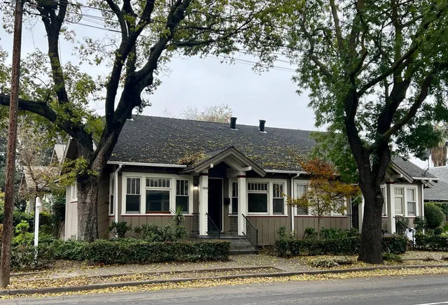 a view of a house with a tree in front