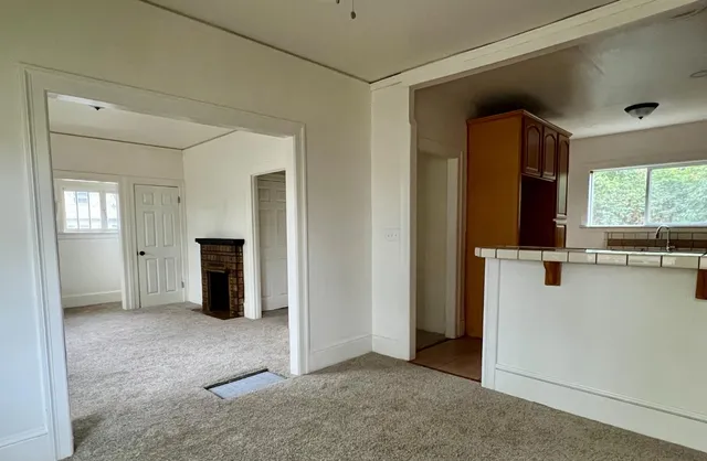 an empty room with windows and closet