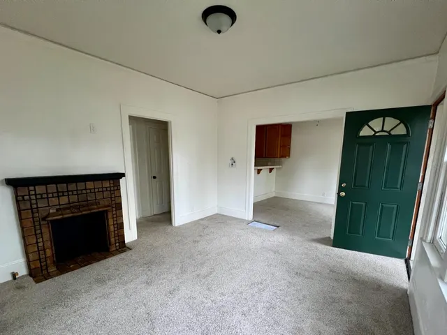 a view of livingroom with hardwood floor and a fireplace
