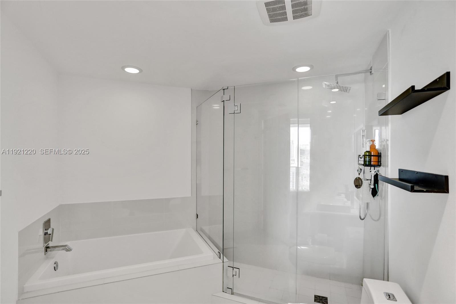 45 Southwest 9th Street, Unit 2001 Miami, FL 33130 - Photo 14 of 48 a bathroom with a bathtub and a shower