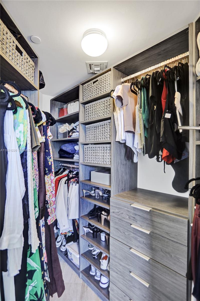 45 Southwest 9th Street, Unit 2001 Miami, FL 33130 - Photo 15 of 48 a view of walk in closet with clothes and shoes