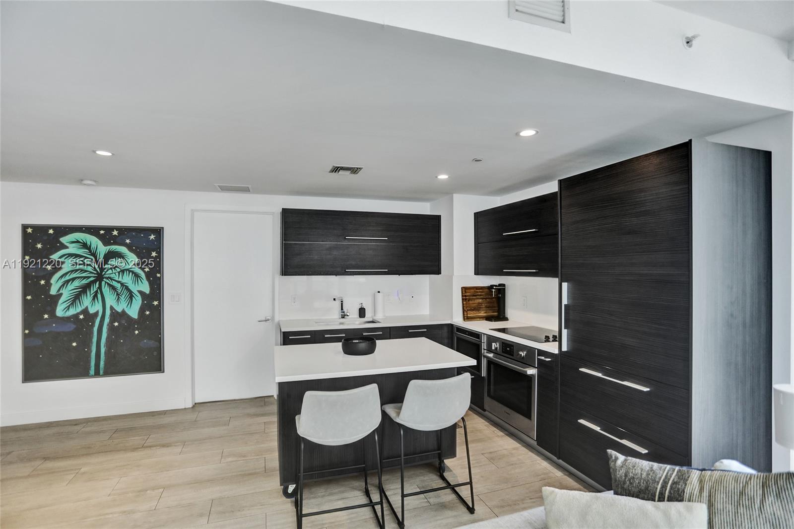 45 Southwest 9th Street, Unit 2001 Miami, FL 33130 - Photo 5 of 48 a kitchen with a sink cabinets and stainless steel appliances