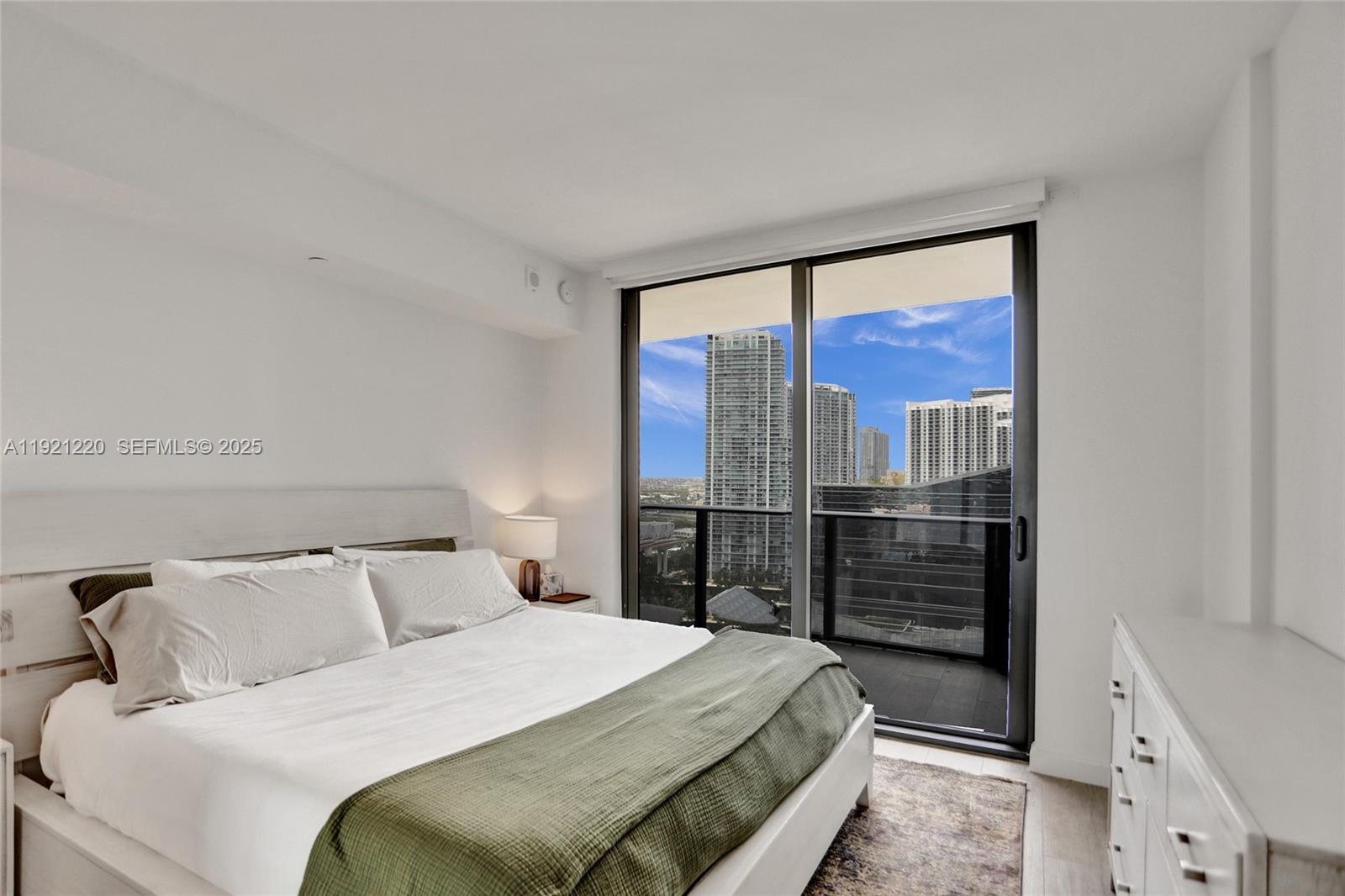 45 Southwest 9th Street, Unit 2001 Miami, FL 33130 - Photo 10 of 48 a bedroom with a large bed and a window