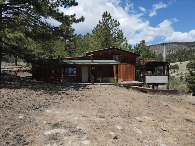 a front view of a house with yard and seating space