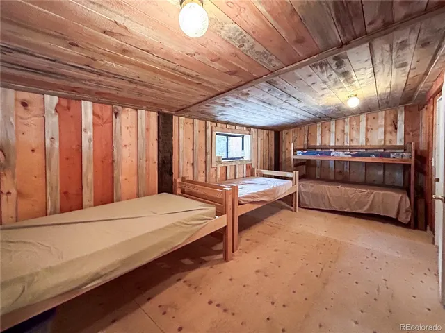 a spacious bedroom with a bed and a large window