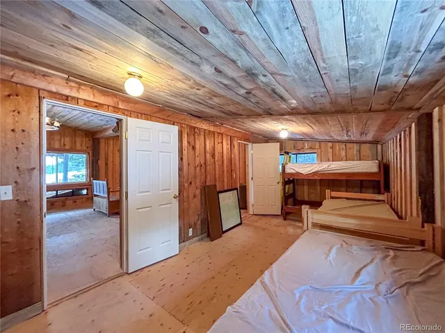 a view of a livingroom with furniture and a hallway