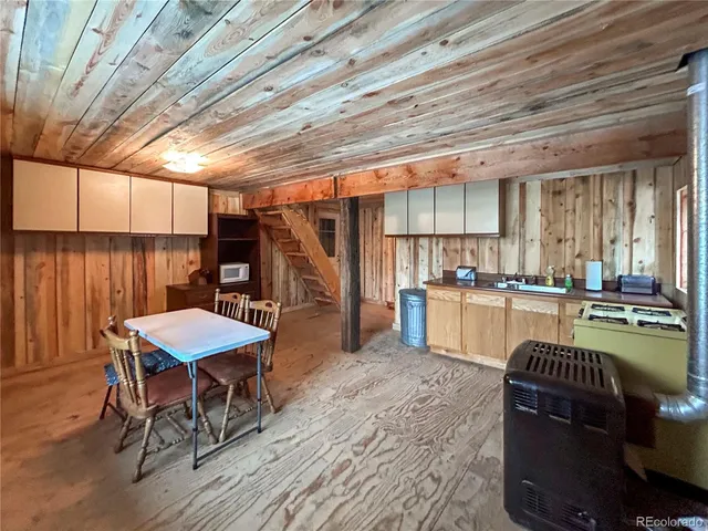 a kitchen with a table chairs stove and refrigerator