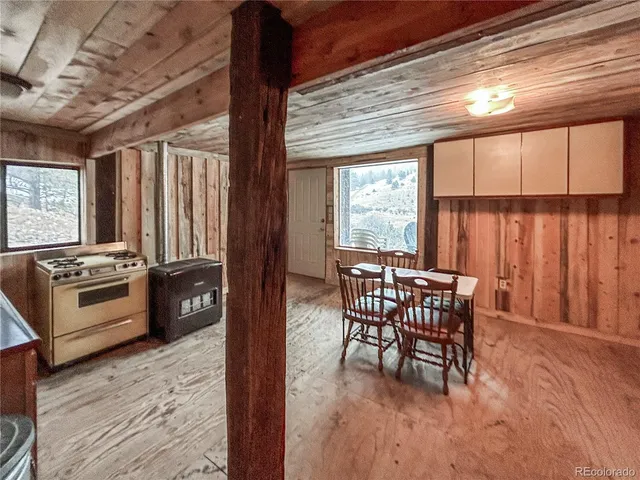 a view of a dining room with furniture and windows