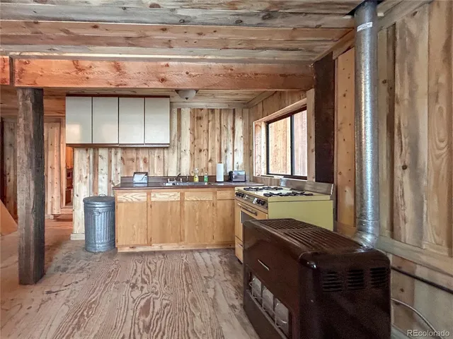 a kitchen with a sink stove and cabinets