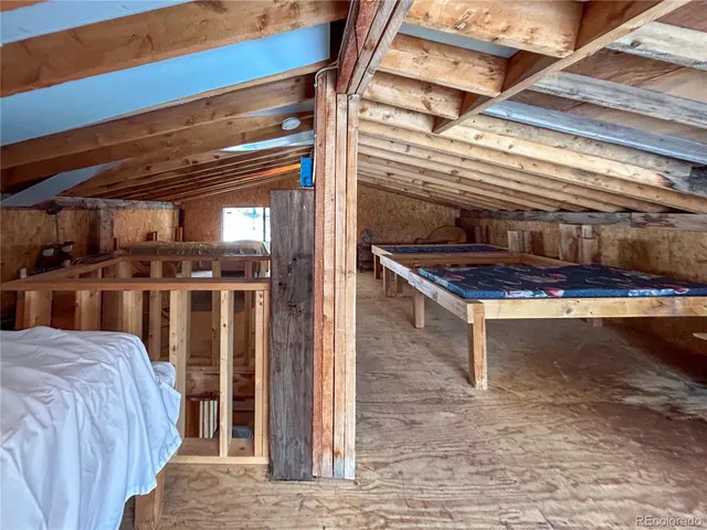 a bed sitting in a bedroom next to a larger window