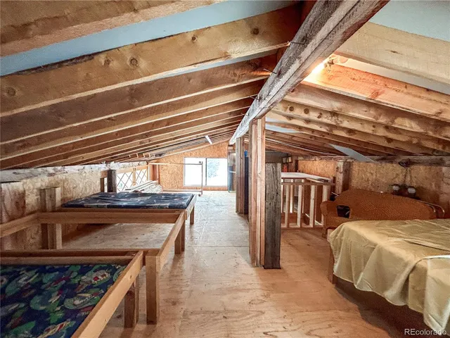 a blue bed sitting in a room next to a window