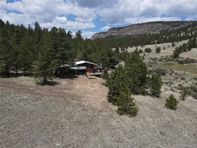 a view of a yard with a table and chairs