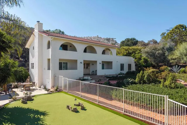 a view of a house with swimming pool and sitting area