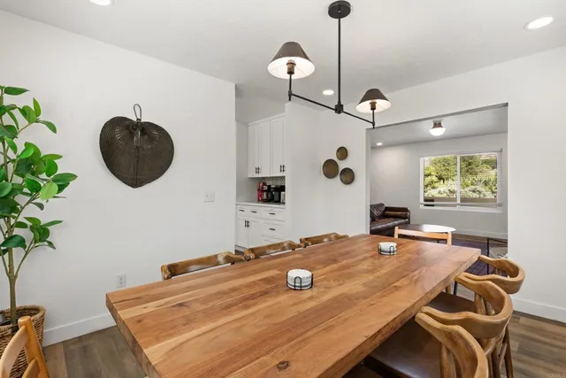 a kitchen with a table chairs a sink and appliances
