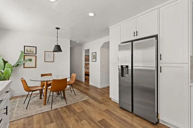 a kitchen with stainless steel appliances granite countertop a refrigerator and a sink