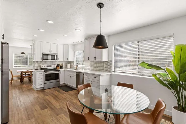a living room with furniture a window and a table