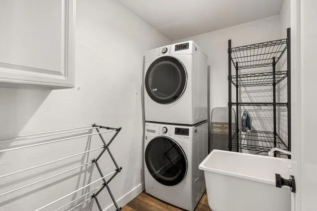 a bathroom with double vanity sink a mirror a toilet and a window