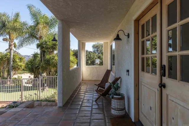 a view of a hallway with wooden floor and entryway