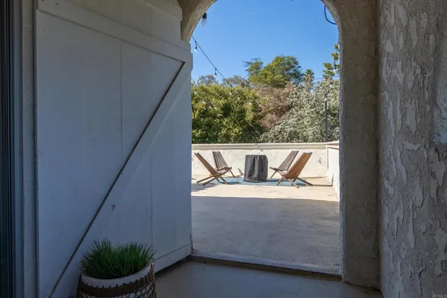 an aerial view of a house with a yard and greenery