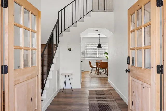 a view of entryway and hall with wooden floor