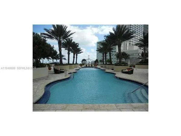 a view of swimming pool with outdoor seating and plants